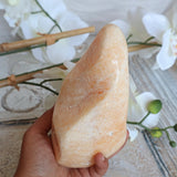 Large Orange Calcite Stone: Free Form Decor on Wooden Stand