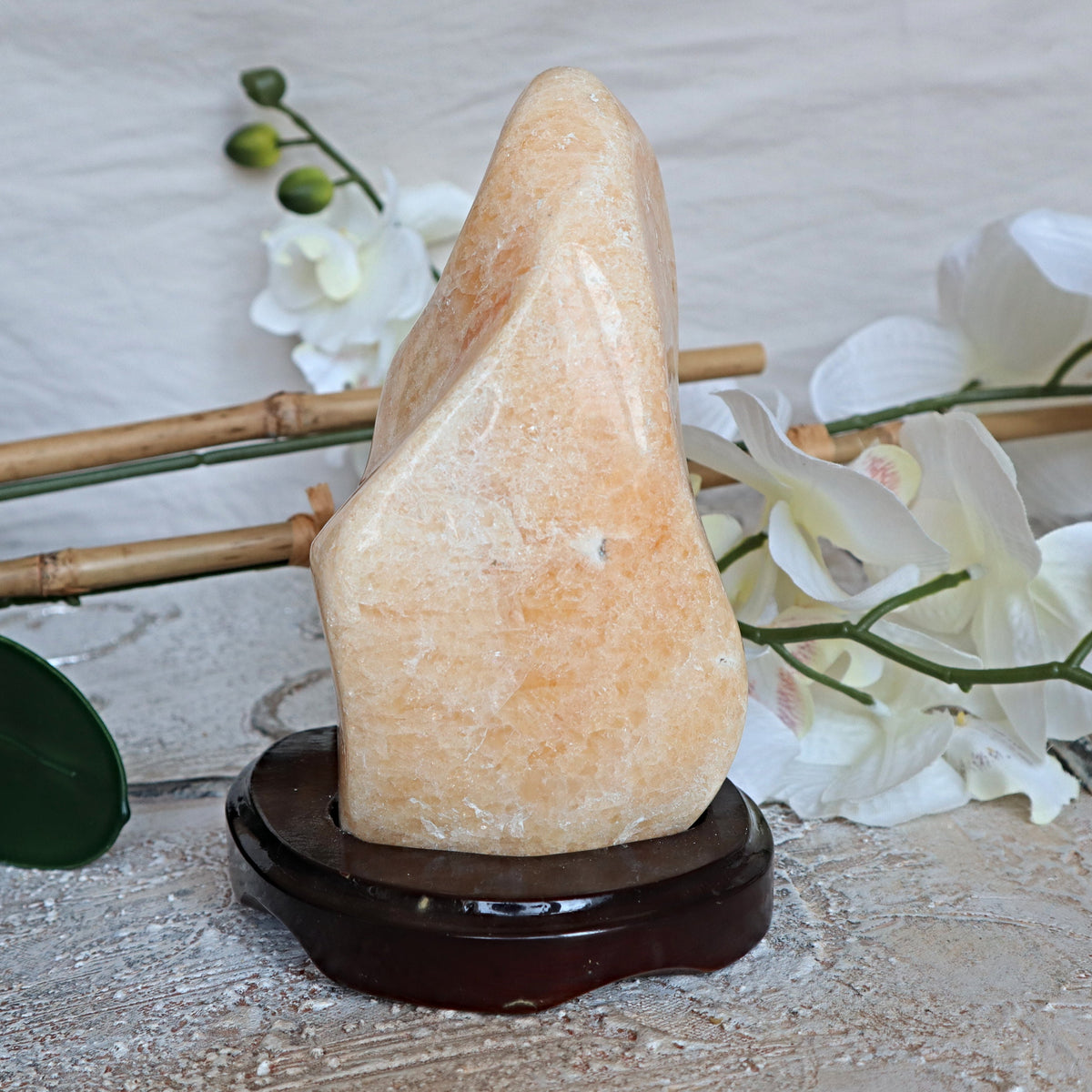 Large Orange Calcite Stone: Free Form Decor on Wooden Stand