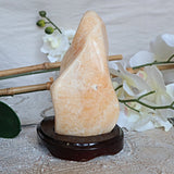 Large Orange Calcite Stone: Free Form Decor on Wooden Stand