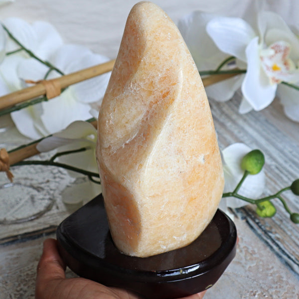 Large Orange Calcite Stone: Free Form Decor on Wooden Stand