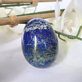 Large Lapis Lazuli egg with golden pyrite flecks on a white background