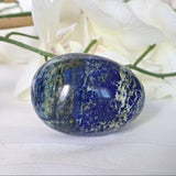 Side view of a natural blue Lapis Lazuli egg showing white calcite veining