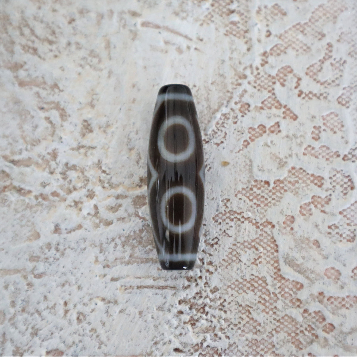Three eye Tibetan Dzi bead close up
