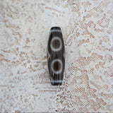Three eye Tibetan Dzi bead close up