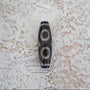 Three eye Tibetan Dzi bead close up