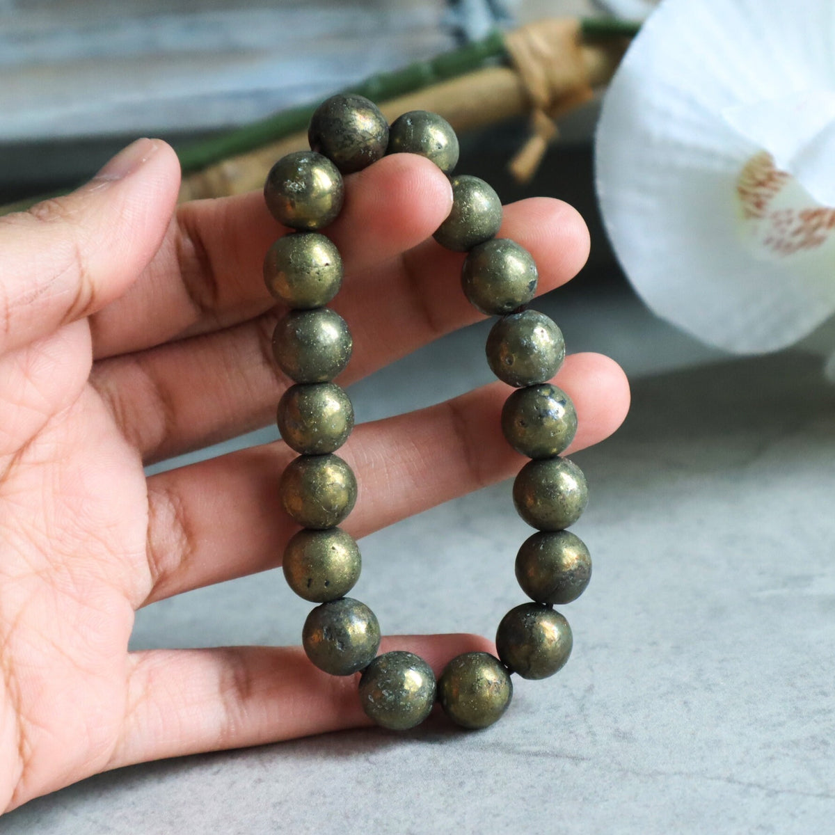 Close up of genuine iron pyrite beads highlighting natural mineral imperfections and shine.