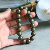 Close up of genuine iron pyrite beads highlighting natural mineral imperfections and shine.