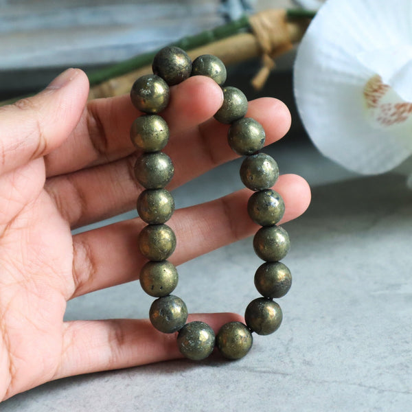 Close up of genuine iron pyrite beads highlighting natural mineral imperfections and shine.