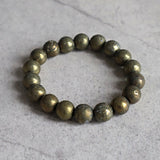 Close up of genuine iron pyrite beads highlighting natural mineral imperfections and shine.
