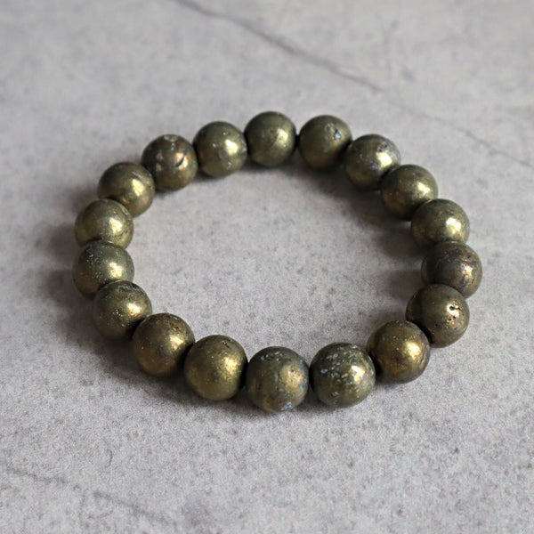 Close up of genuine iron pyrite beads highlighting natural mineral imperfections and shine.