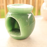 Close-up of green aventurine crystal base with essential oil dish
