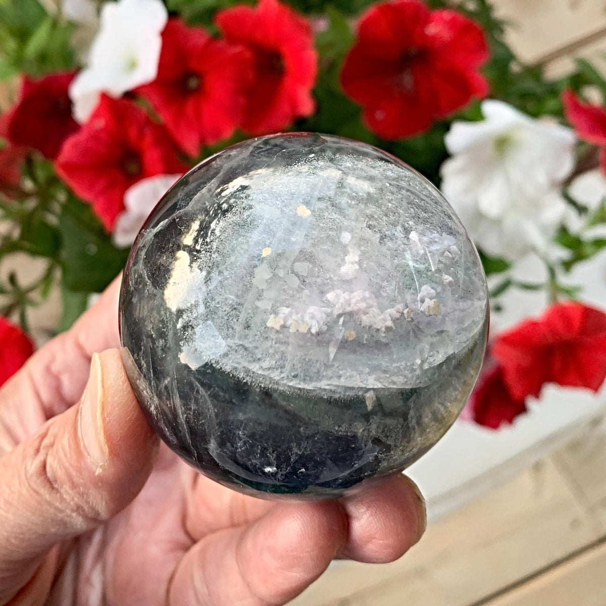 Garden quartz sphere with moss-like inclusions