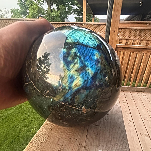 Polished labradorite sphere showing golden iridescence
