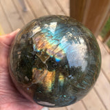Large labradorite sphere with vibrant blue and golden flashes