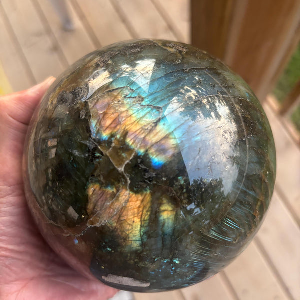 Large labradorite sphere with vibrant blue and golden flashes