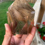 Smoky rutilated quartz tower with golden rutile