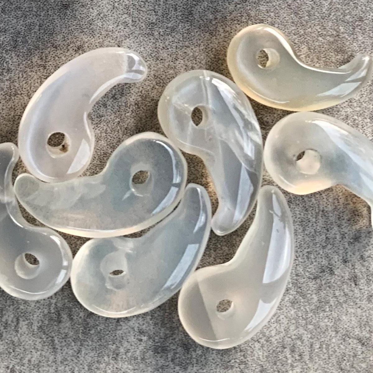 1.	Moonstone Magatama amulet charm with iridescent glow