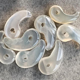 1.	Moonstone Magatama amulet charm with iridescent glow