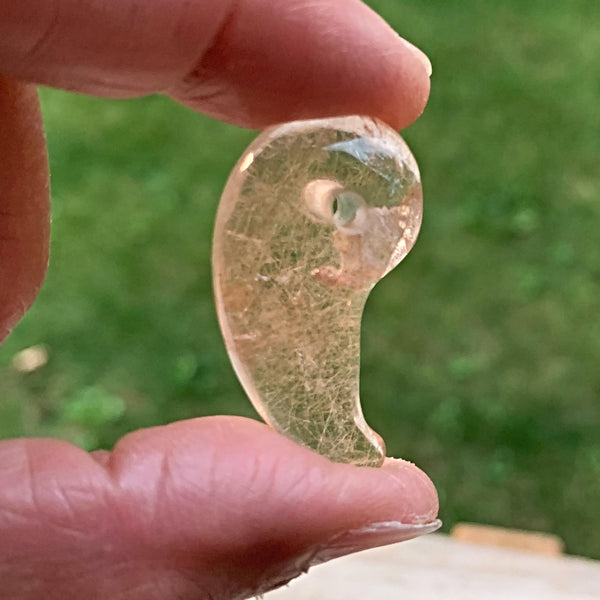 Rutilated quartz magatama amulet with gold rutile