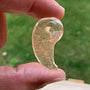 Rutilated quartz magatama amulet with gold rutile
