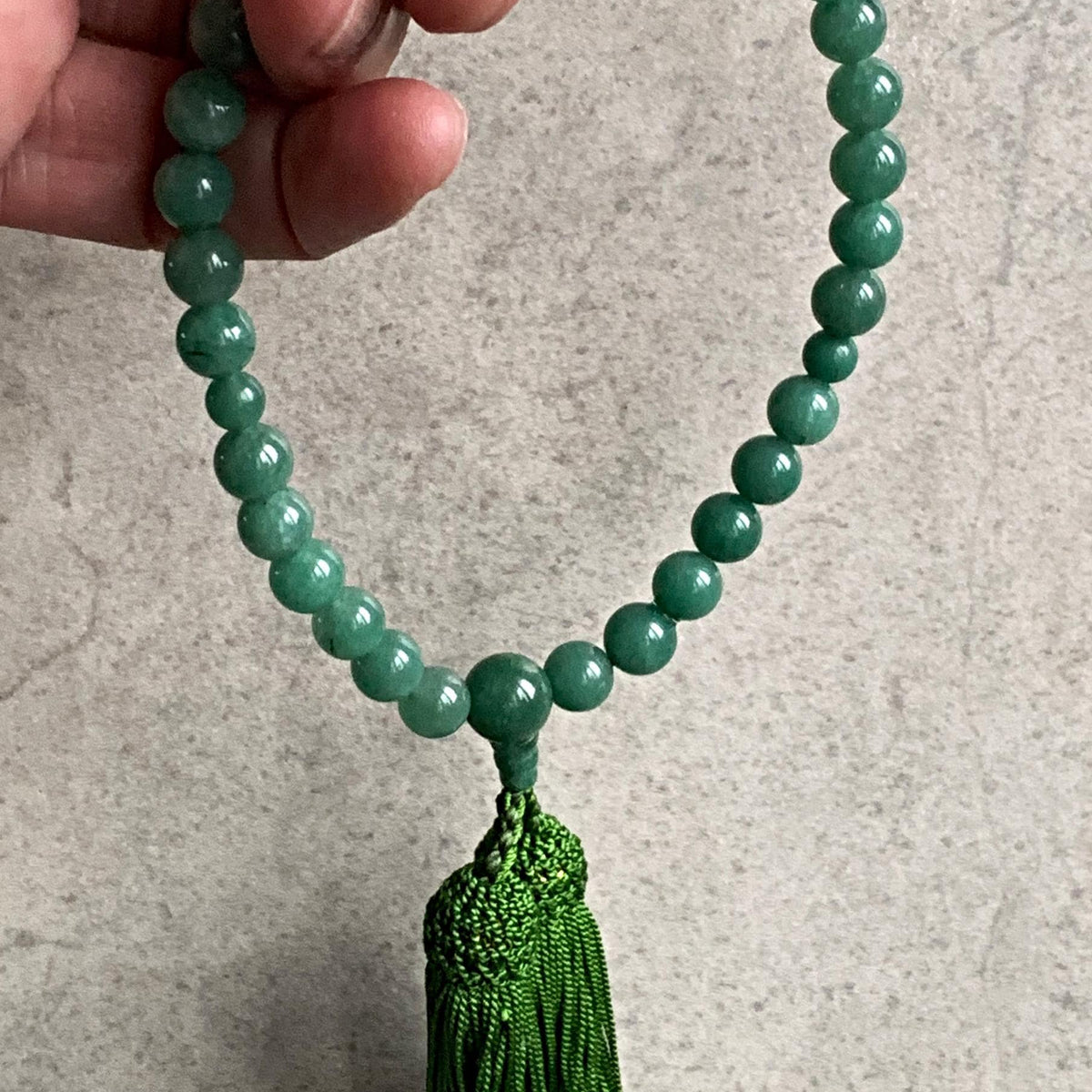 green tassel prayer beads