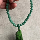 green tassel prayer beads