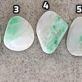 Green jadeite pocket palm stone close-up