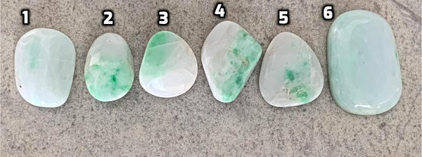 Green jadeite pocket palm stone close-up