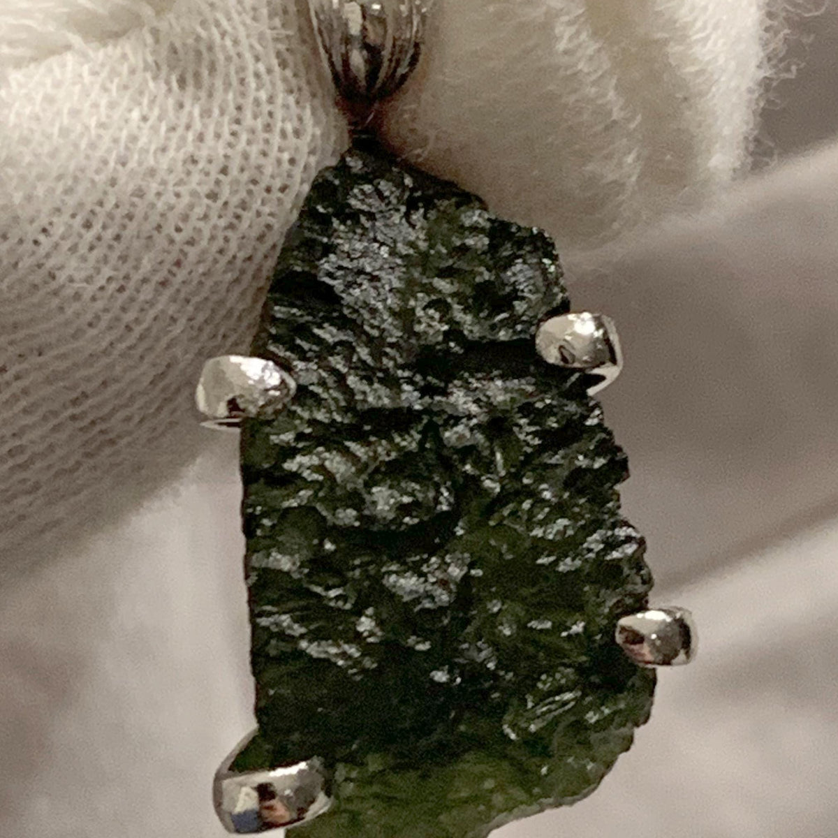 green moldavite crystal pendant close up