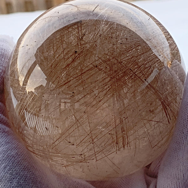 Large rutilated quartz crystal ball
