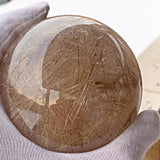 Golden rutilated quartz sphere