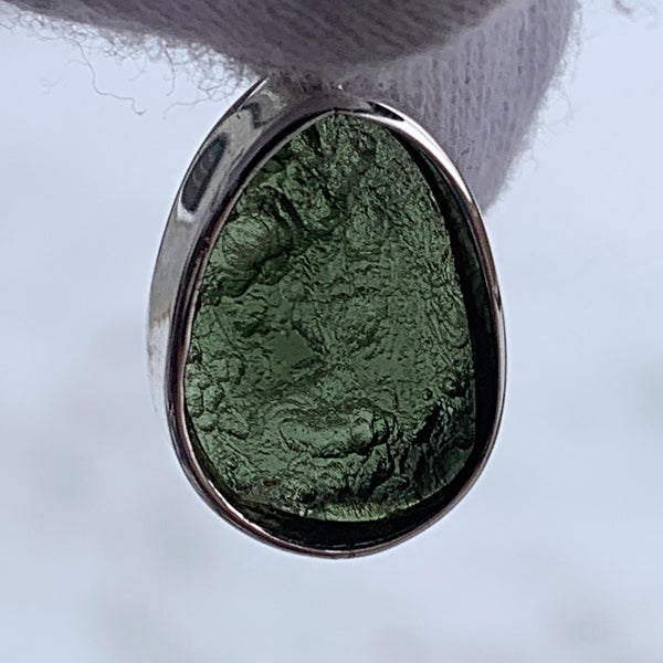 Moldavite teardrop pendant with polished and raw sides