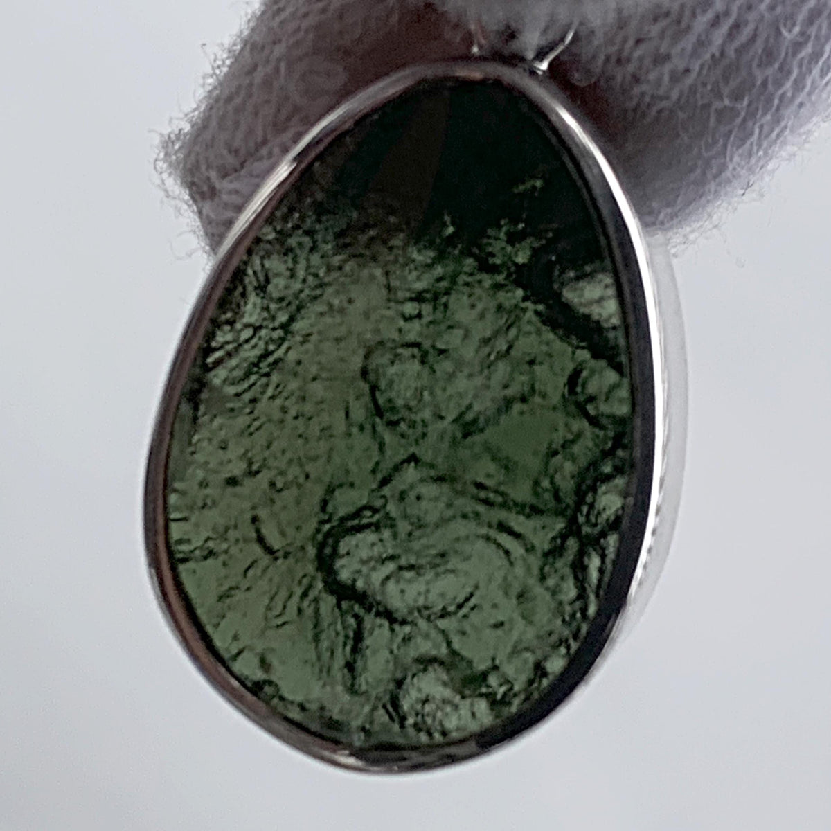 Dual sided moldavite pendant raw and polished view