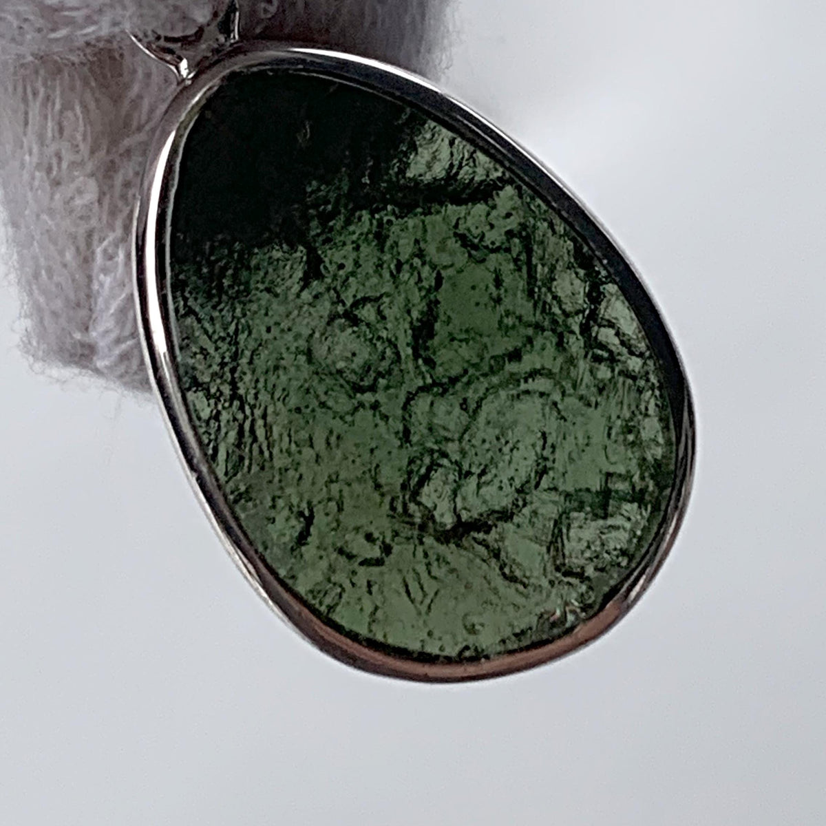 Dual sided moldavite pendant raw and polished view