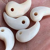 Polished opal magatama spiritual amulet close up