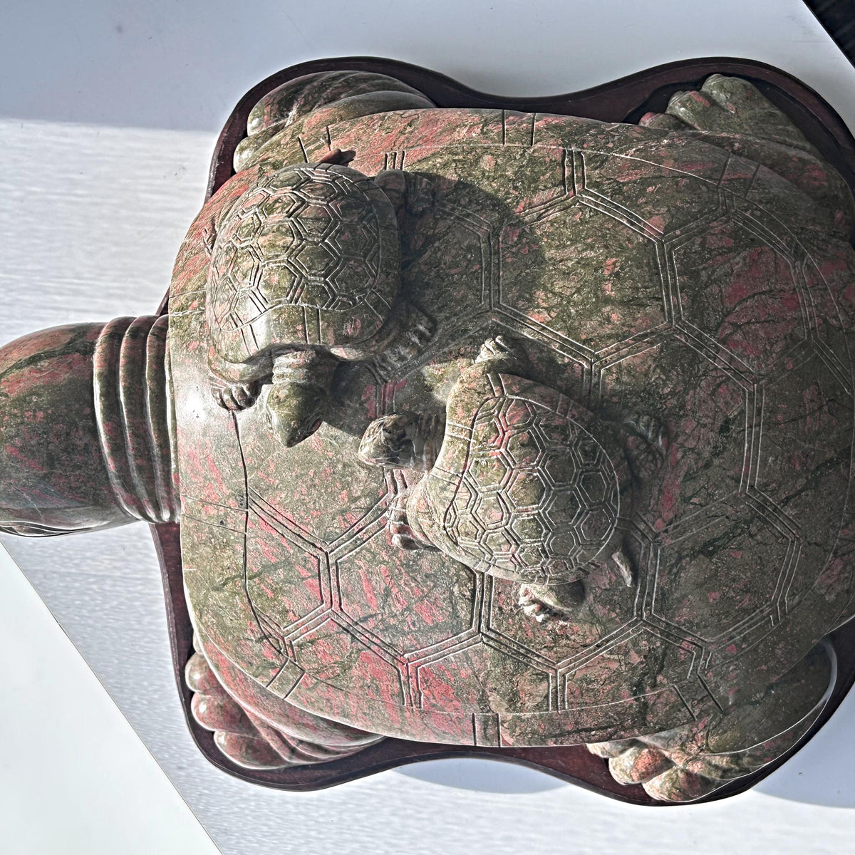 Large unakite sculpture on wooden stand
