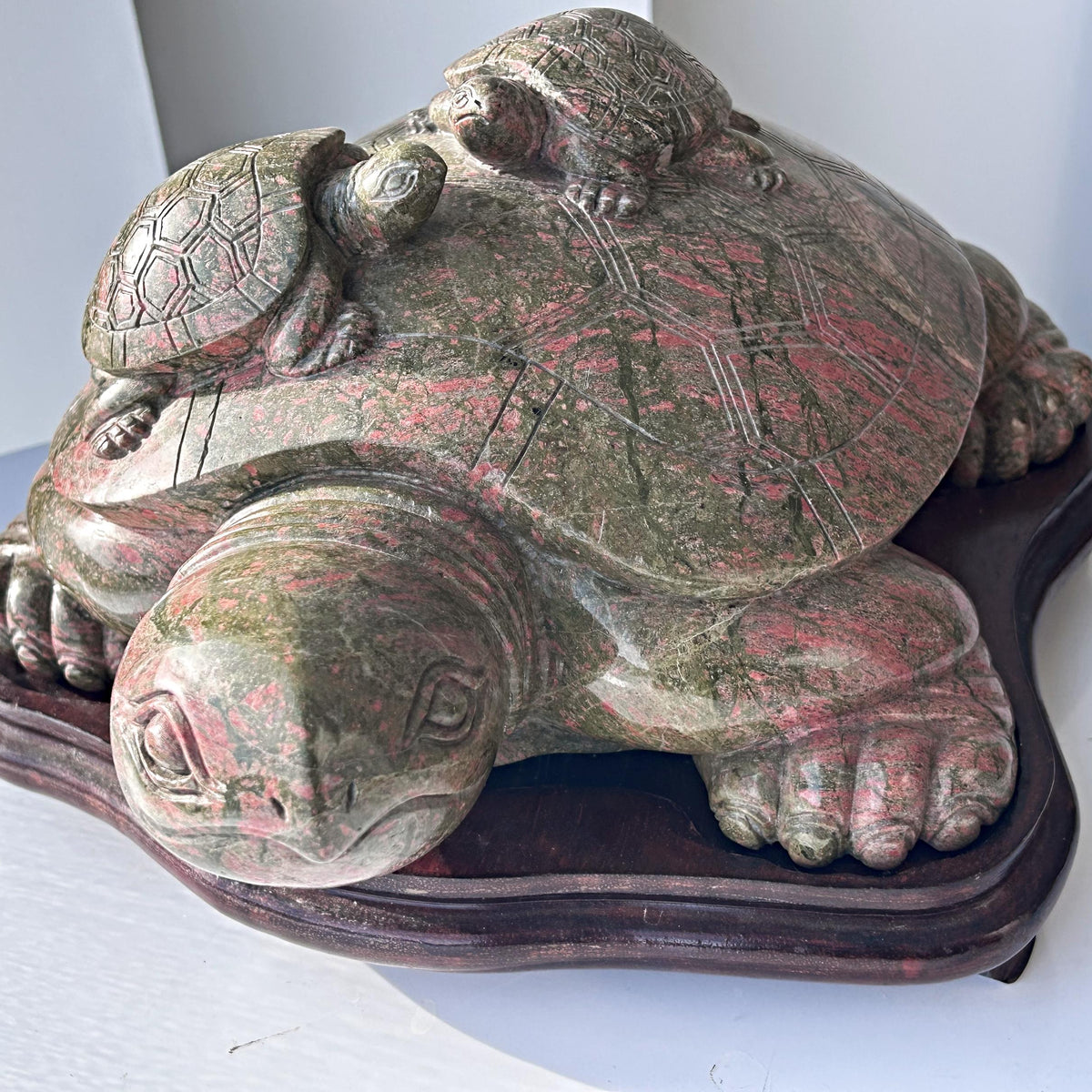 Large unakite sculpture on wooden stand