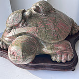 Large unakite sculpture on wooden stand