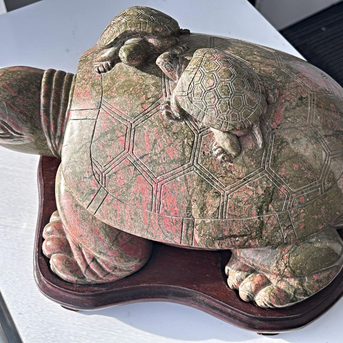 Large unakite sculpture on wooden stand