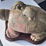 Large unakite sculpture on wooden stand