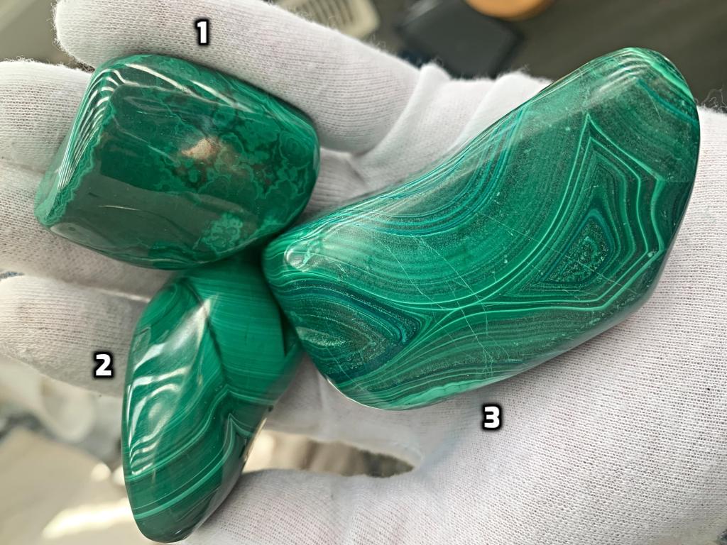 A variety of malachite freeform shapes in different sizes ranging from emerald to forest green