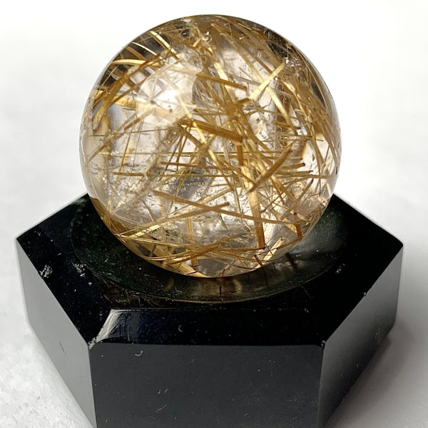 Golden rutile rutilated quartz sphere close up