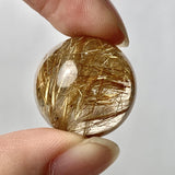 Polished rutilated quartz mineral specimen