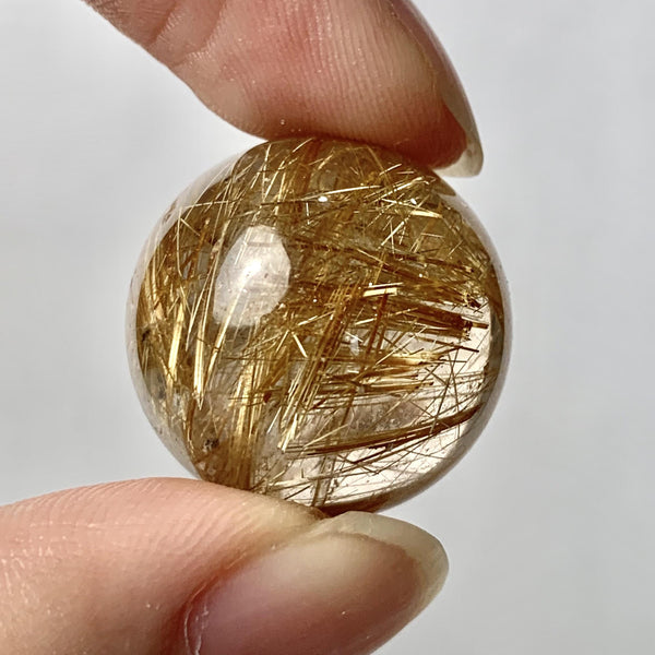 Polished rutilated quartz mineral specimen