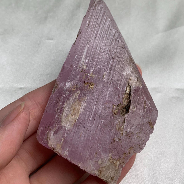 Etched termination kunzite crystal with ridged texture