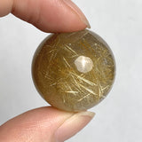 Golden rutile crystal sphere close-up