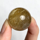 Clear quartz sphere with golden rutile inclusions