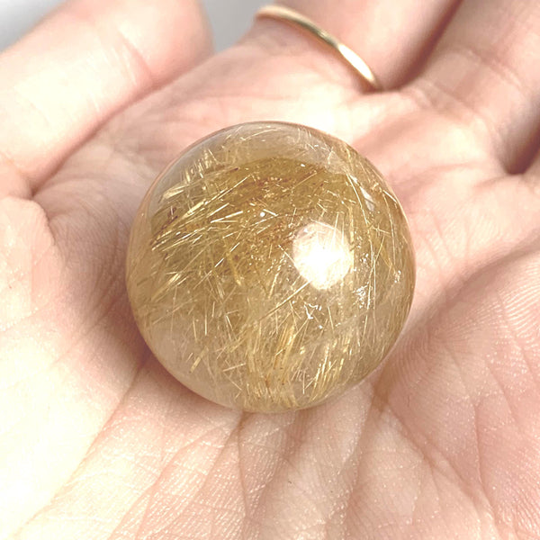 Golden needle quartz sphere close up
