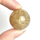Rutilated quartz sphere with golden needles