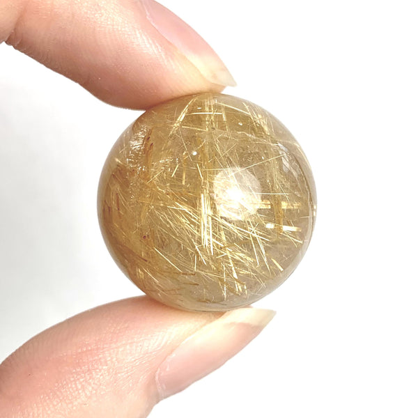 Rutilated quartz sphere with golden needles